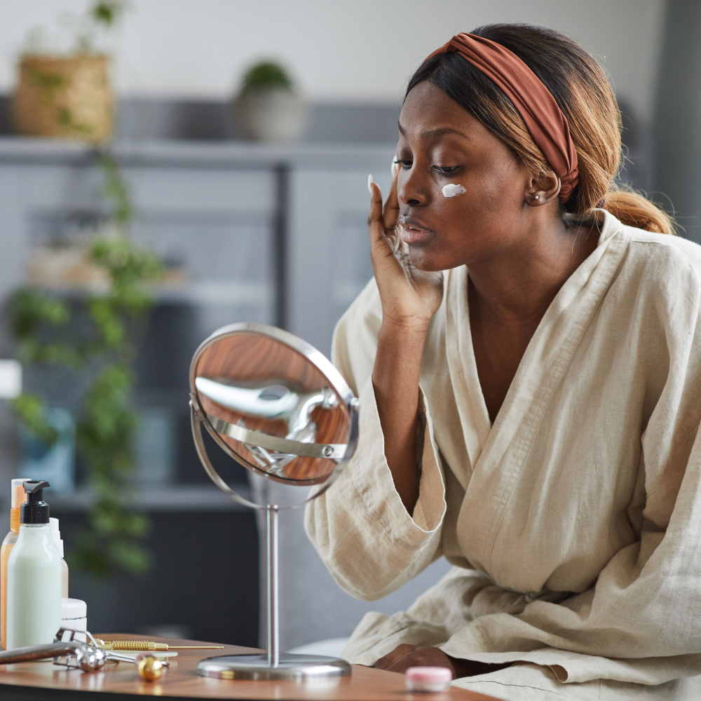 Woman applying face cream during her skincare ritual. 