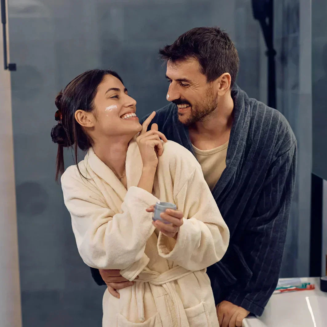 Prioritizing skin health after 40. Woman and Man doing their nightly skincare routine using Eonian Skincare. 